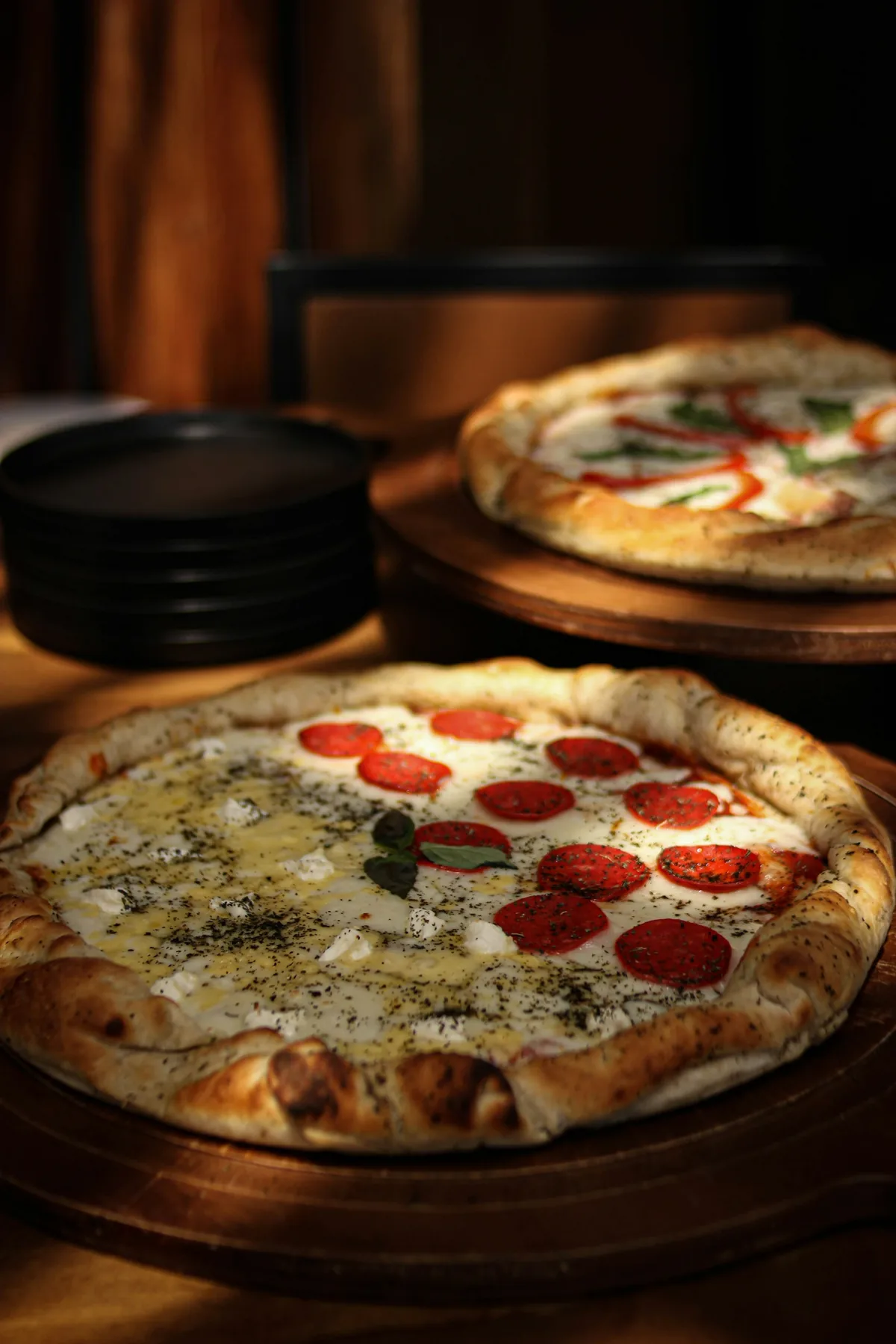 Fresh pizzas and shared plates arranged on a table