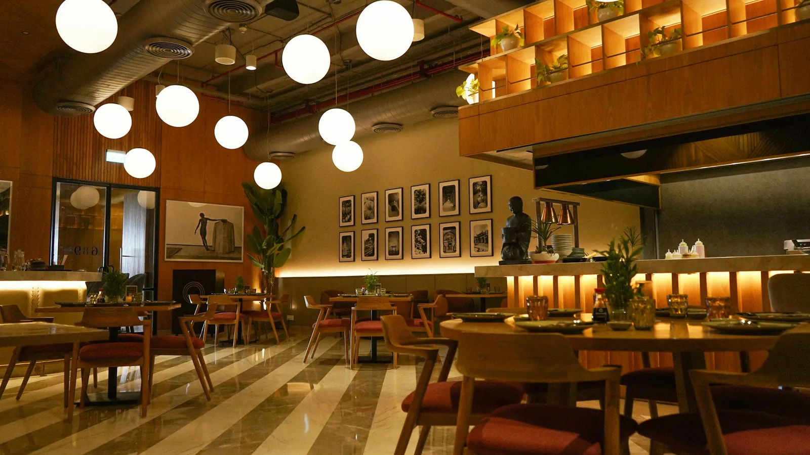Warm modern restaurant interior with dining tables and a bar